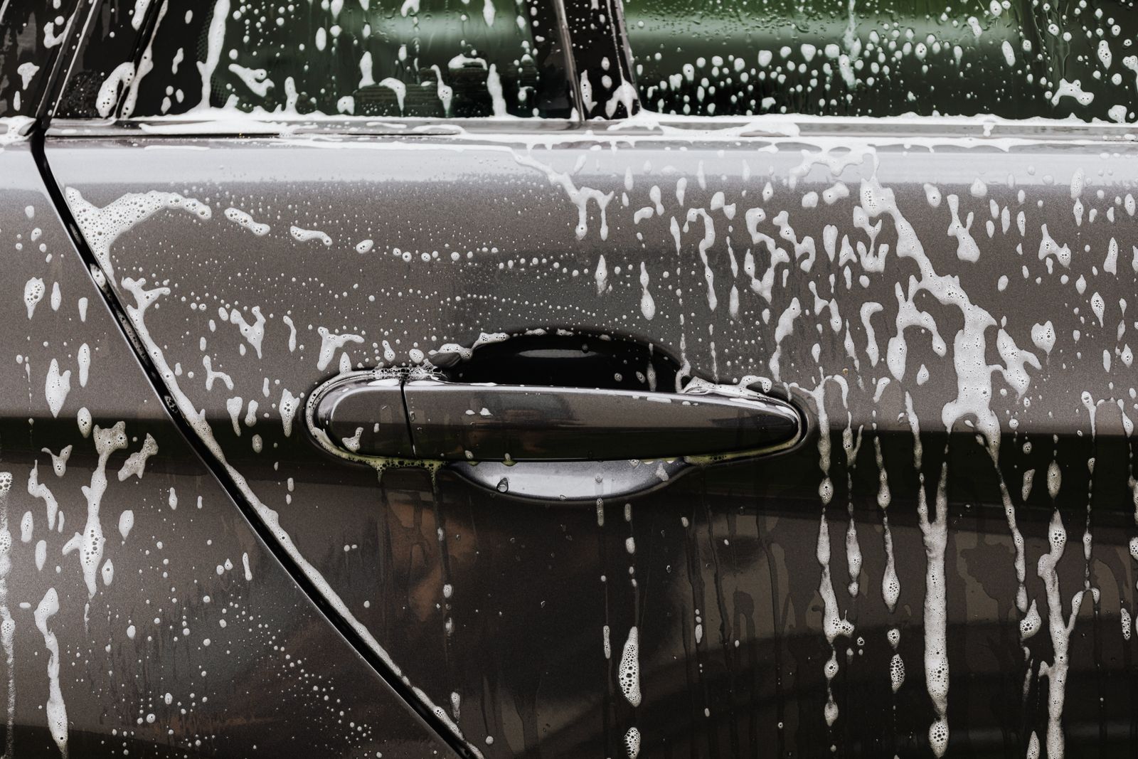 Foam-covered cars at a SudsCity wash