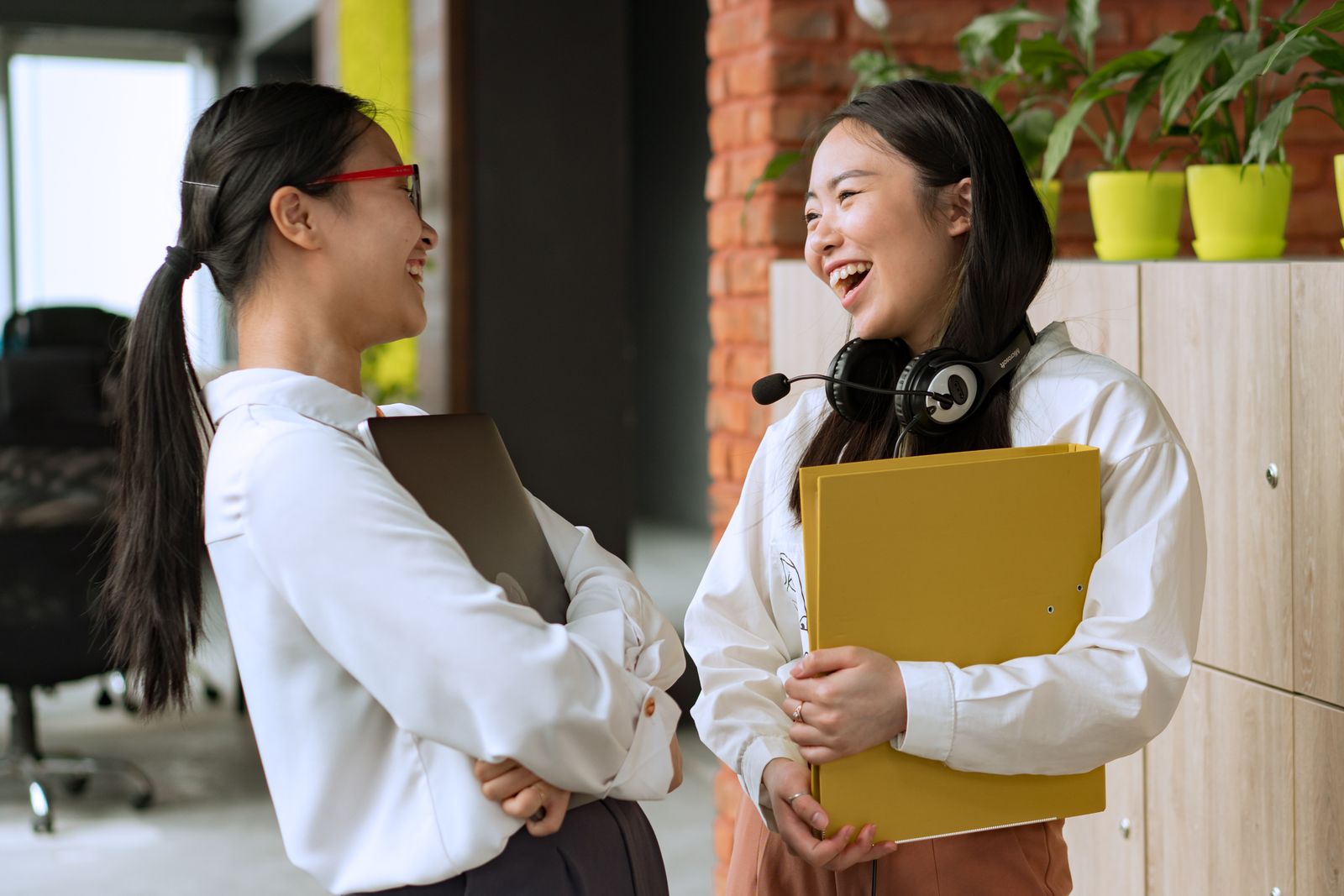 Two coworkers sharing a laugh