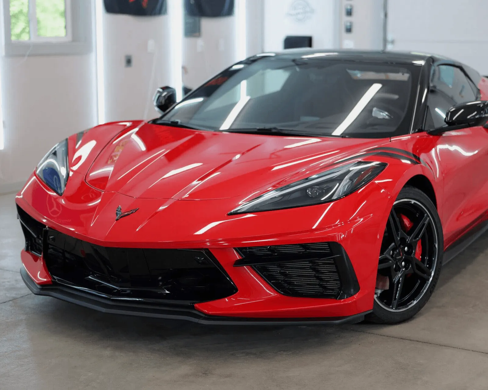 Red mid-engine coupe in a clean bay