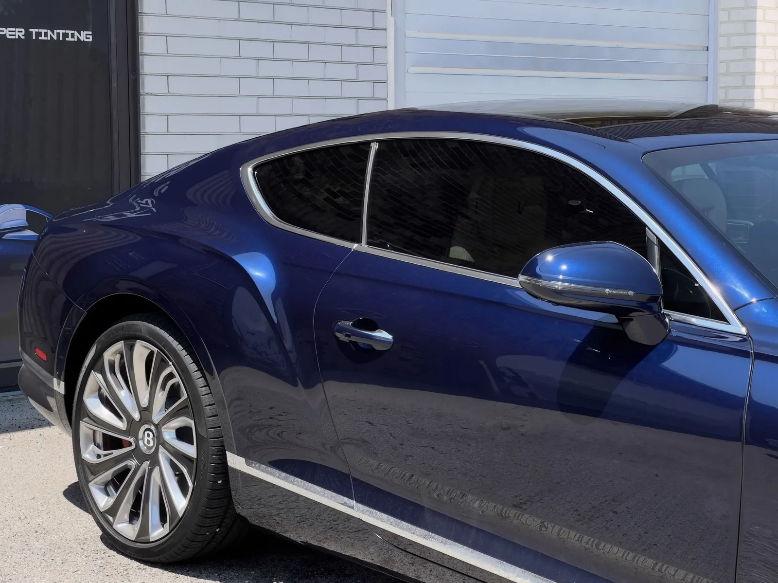 Blue grand tourer with deep gloss