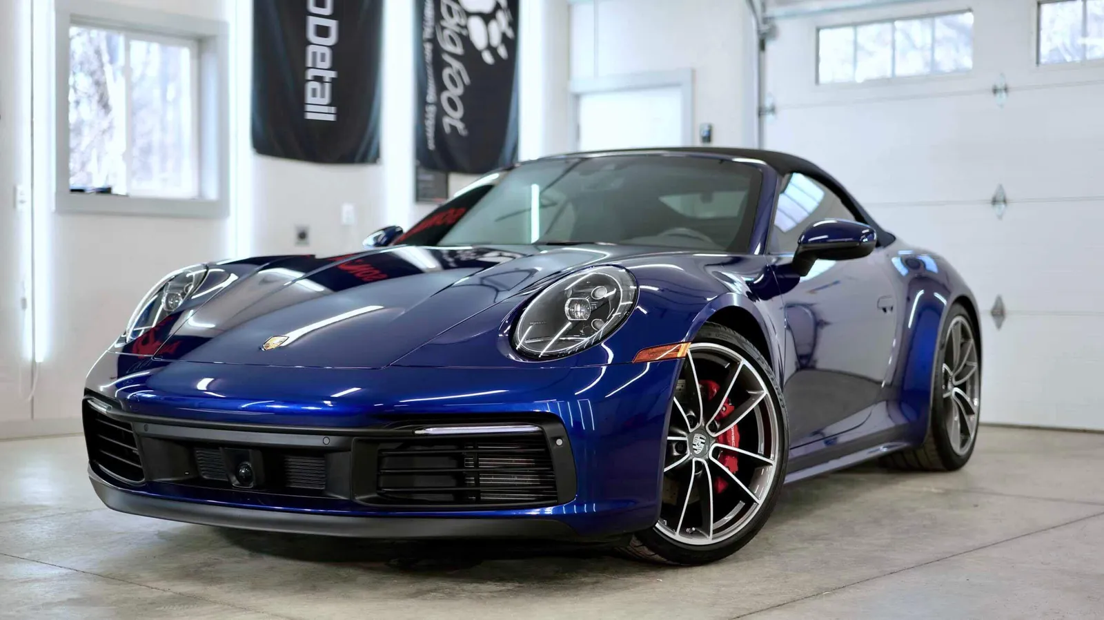 Freshly detailed blue coupe in a bright studio